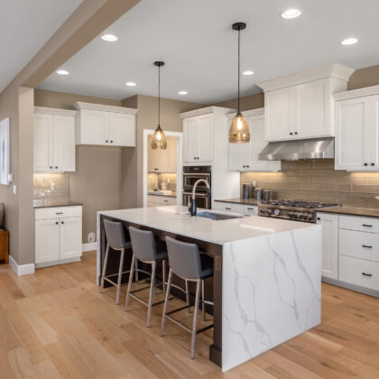 Beautiful kitchen in new luxury home with waterfall island, quar