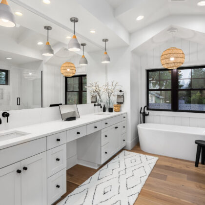 Bathroom in luxury home with double vanity, bathtub, mirror, sinks, shower, and hardwood floor